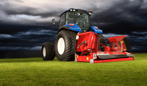 In a Stormy Cloud Background, a Tractor with a Stealth S3 Mower